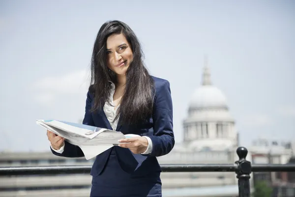 Indian businesswoman holding newspaper — Stock Photo, Image