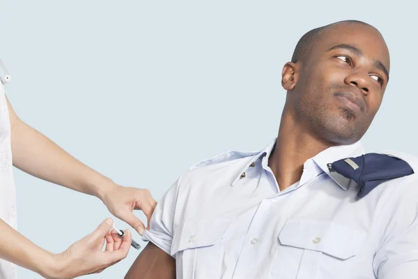 Military man looking away as being injected — Stock Photo, Image