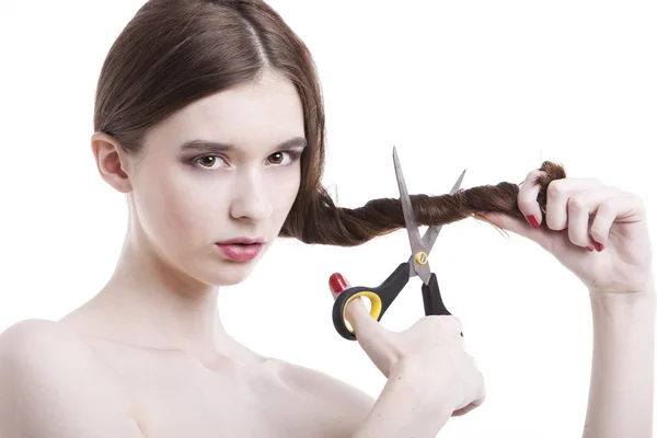 Woman with scissors cutting her hair — Stock Photo, Image