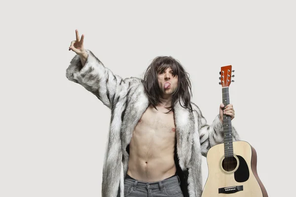 Man in fur coat holding guitar — Stock Photo, Image