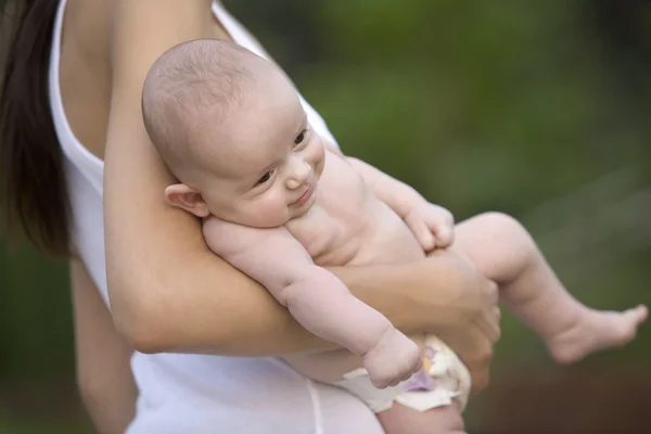 Mother stands holding 2 month old infant son — Stock Photo, Image