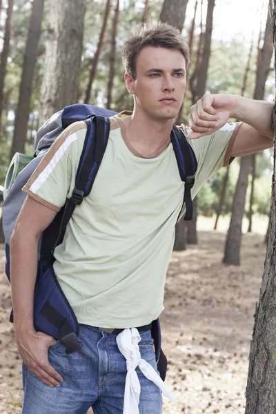 Man med ryggsäck i skogen — Stockfoto