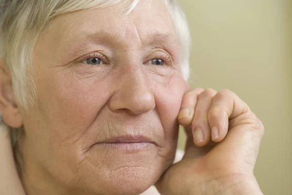 Elderly woman   leaning on hand — Stock Photo, Image