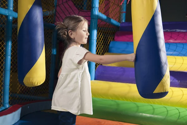 Girl hitting foam object — Stock Photo, Image