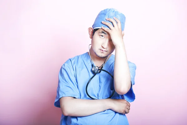 Asian surgeon looking stressed — Stock Photo, Image