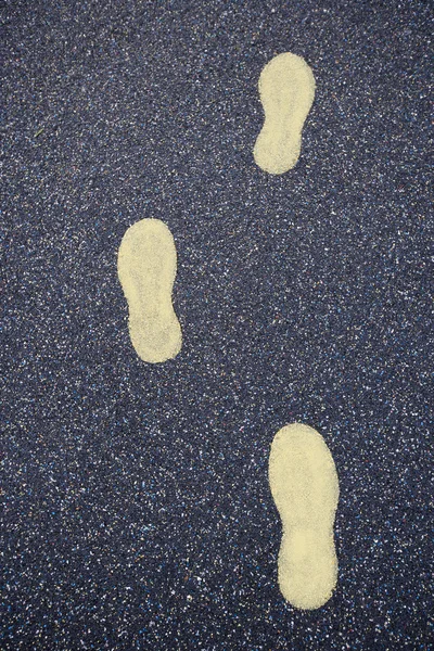 Gelbe Fußstapfen gezogen — Stockfoto