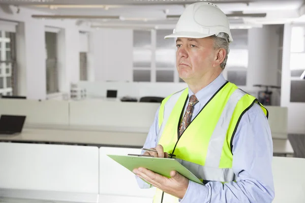 Man in reflector vest and hard hat — Stock Photo, Image