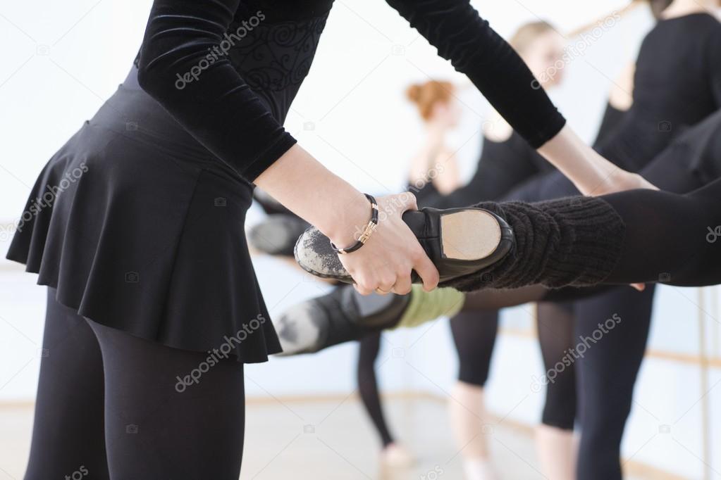 female dancers at barre with teacher 