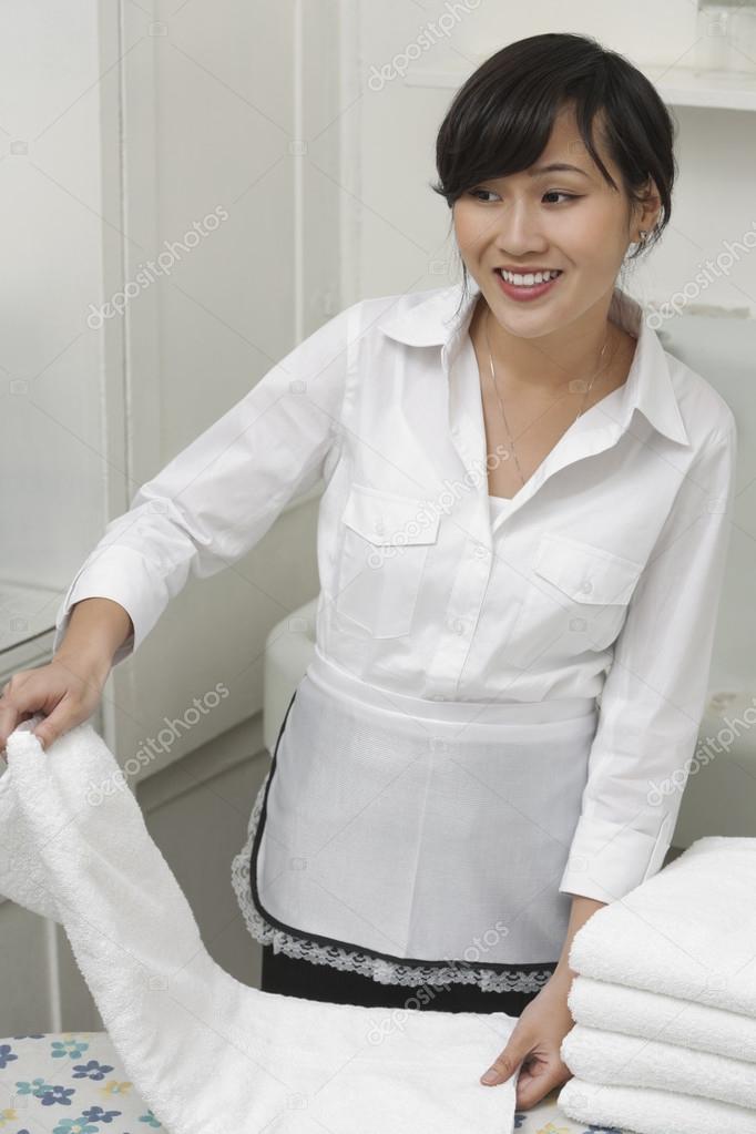 Housekeeper holding towels