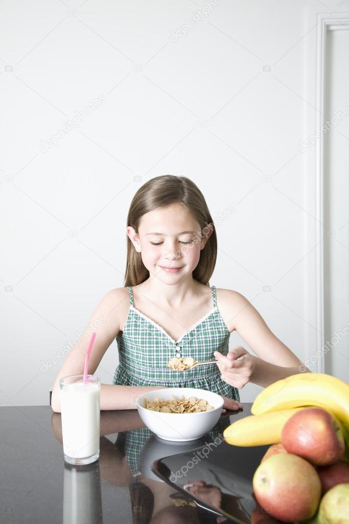 Teen girl having breakfast