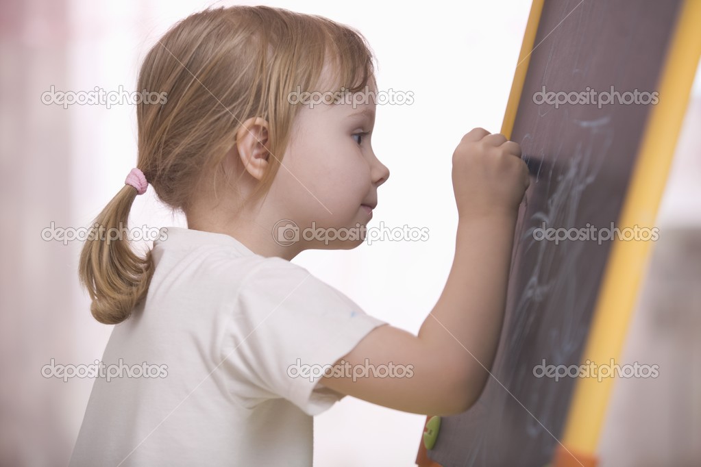 girl drawing on chalkboard