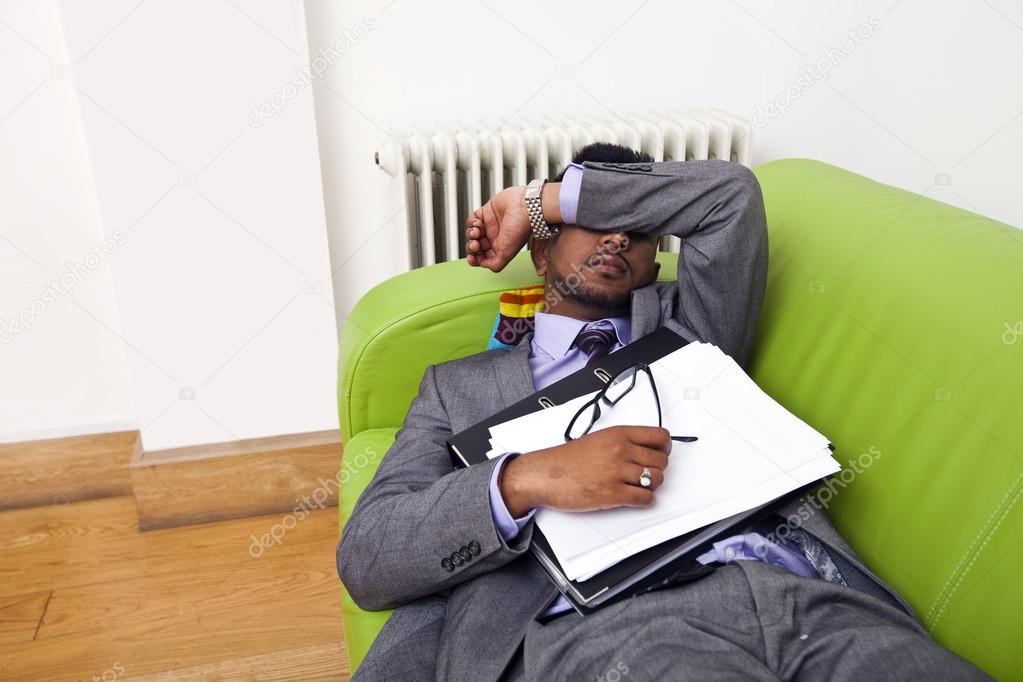 Businessman sleeping on a sofa