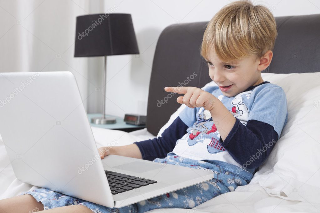 Playful boy using laptop