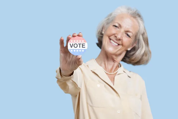 Senior woman with election badge — Stock Photo, Image