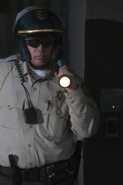 Patrolman with flashlight — Stock Photo, Image