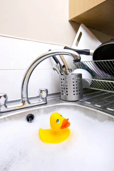 Rubber duck in kitchen sink — Stock Photo, Image