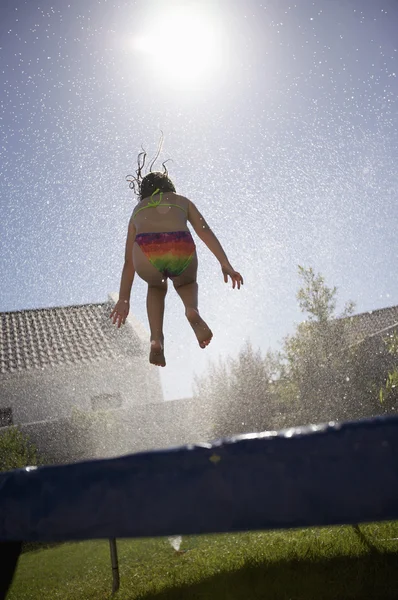 Girl jumping on trampoline — Stock Photo, Image