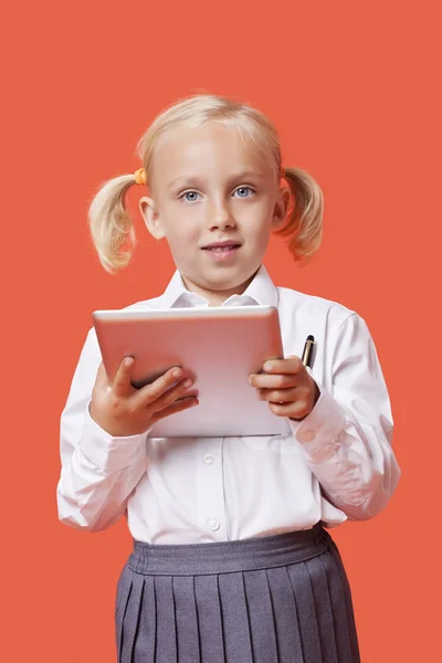 Schoolgirl holding tablet PC — Stock Photo, Image