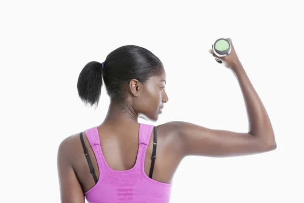 Young woman raising dumbbell — Stock Photo, Image