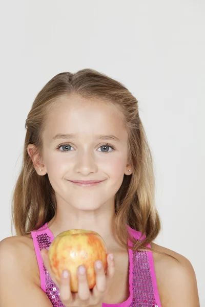 Girl holding an apple — Stock Photo, Image