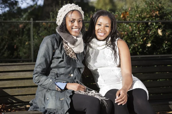 Women relaxing on park bench — Stock Photo, Image