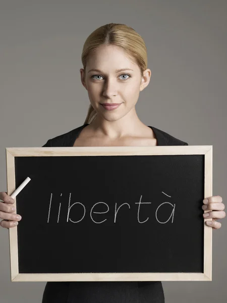 Businesswoman holding blackboard — Stock Photo, Image