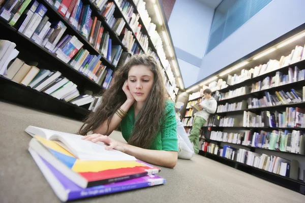 Estudante universitário que estuda na biblioteca — Fotografia de Stock