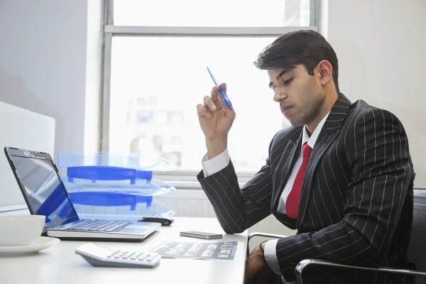 Indian businessman working at office desk — Stockfoto