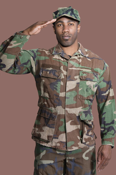 African American US Marine Corps soldier saluting