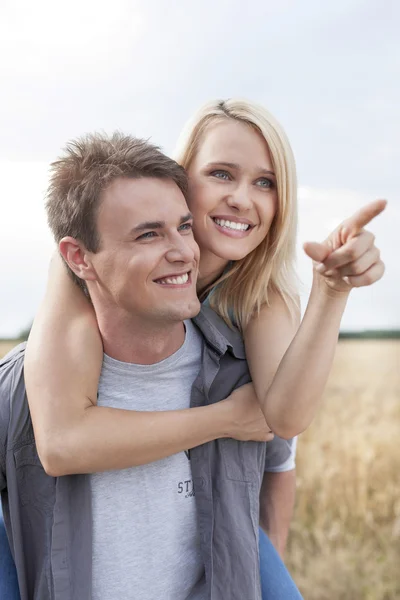 Woman showing something to man Stock Picture
