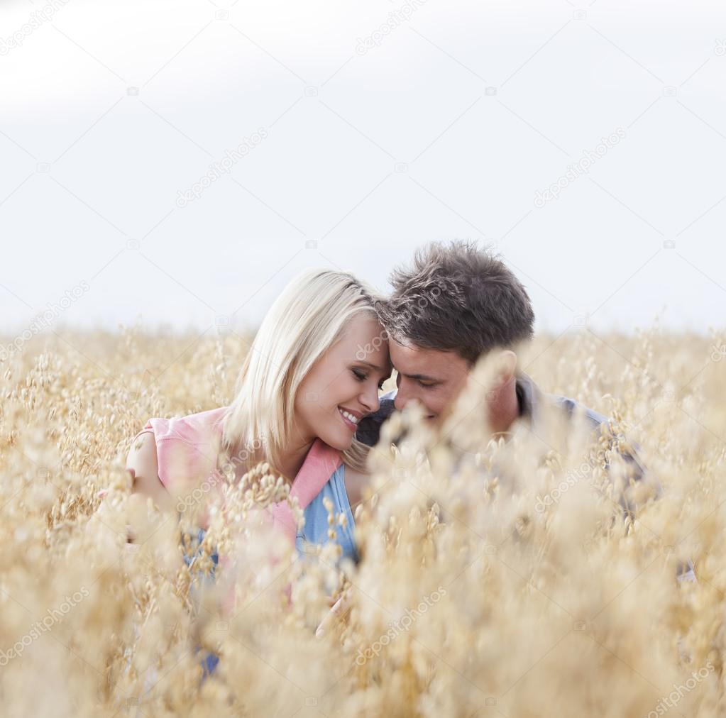 couple sitting amidst field