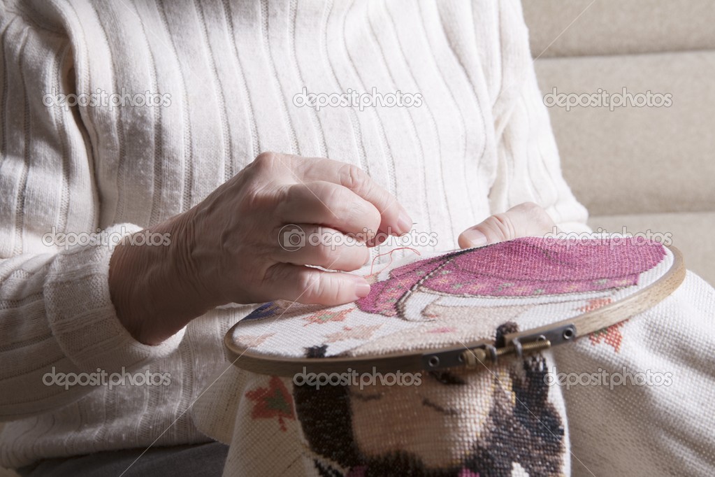 Woman working on needlepoint