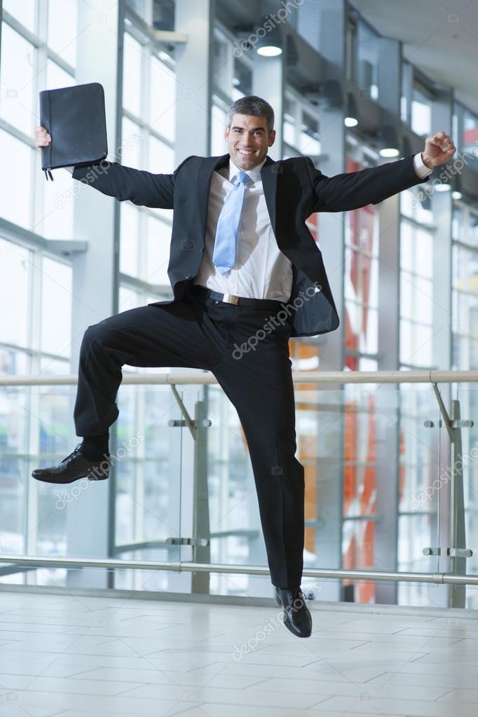 Happy Businessman leaps into the air