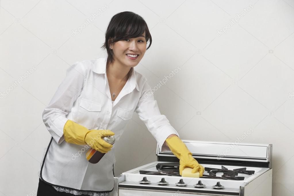 Maidservant cleaning stove