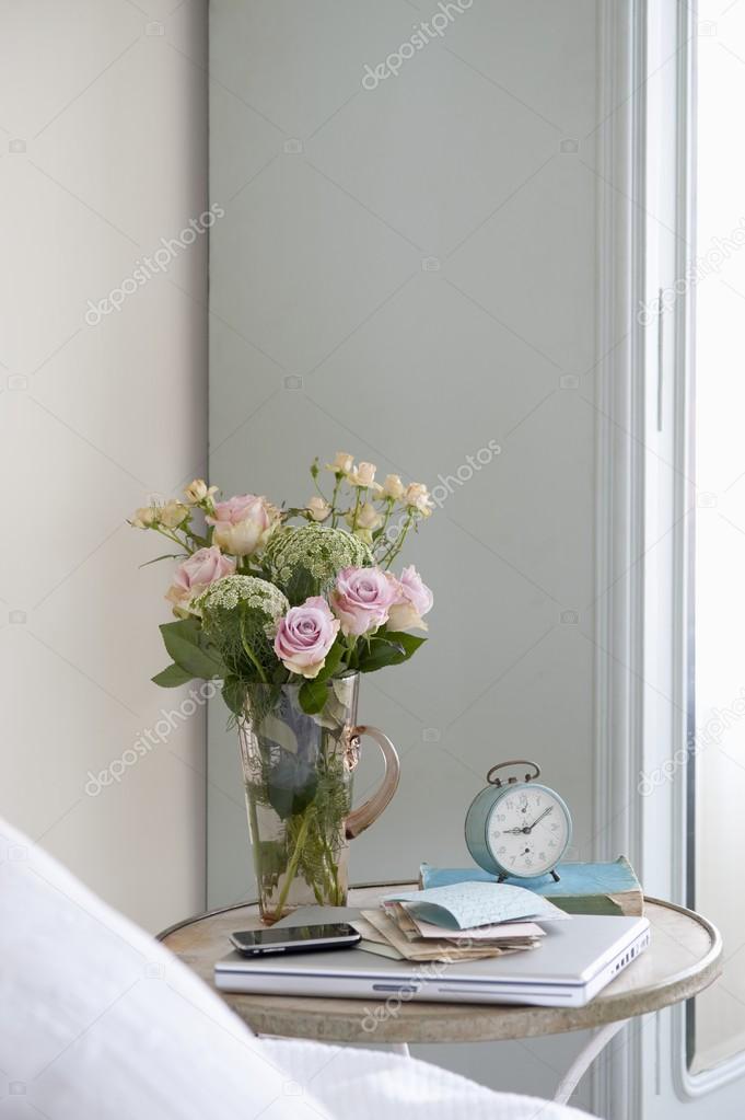 Roses in vase  with books 