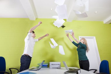 Businesspeople throwing documents in office clipart