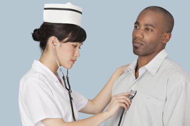 Doctor listening heartbeat of patient clipart