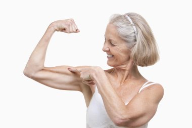 Senior woman flexing muscles clipart