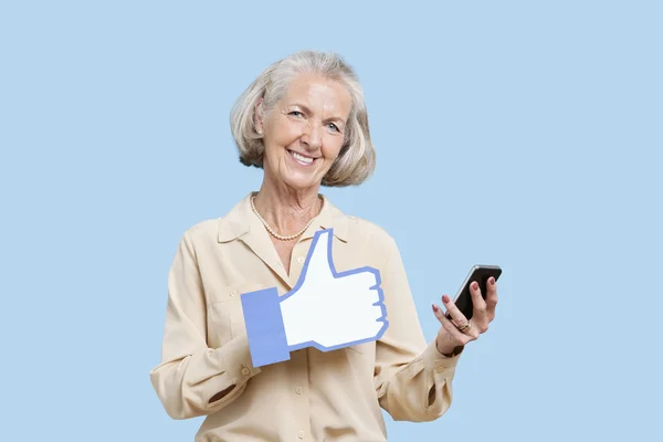 Senior woman with phone and fake like button — Stock Photo, Image