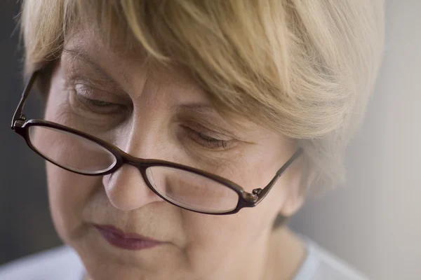 Mature woman in reading glasses — Stock Photo, Image