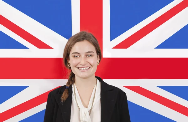 Empresária sorrindo sobre a bandeira britânica — Fotografia de Stock