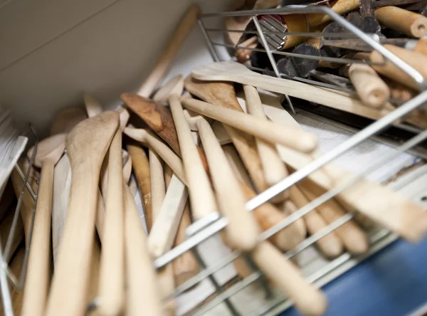 Wooden spatulas on shelf — Stock Photo, Image