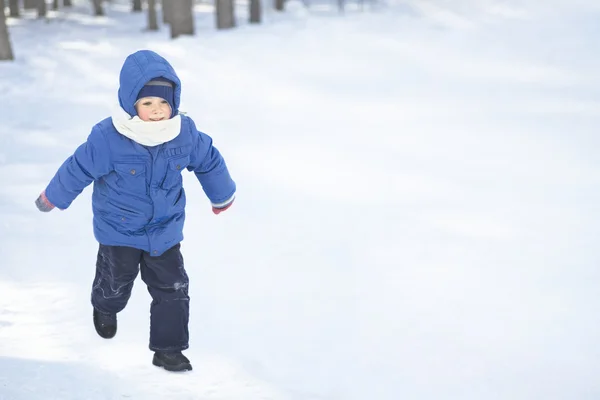 Jongen uitgevoerd in de sneeuw — Stockfoto