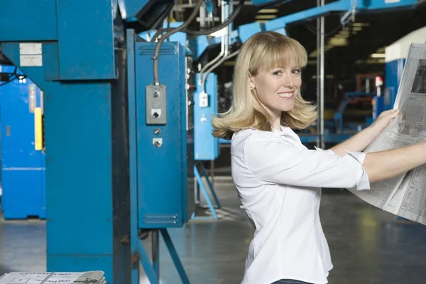 Woman checking newspaper — Stock Photo, Image