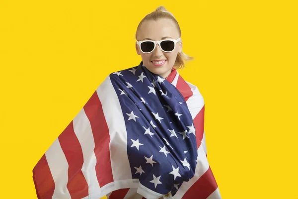 Woman wrapped in American flag — Stock Photo, Image