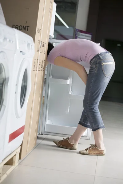 Young woman with her head in a fridge — Stock Photo, Image