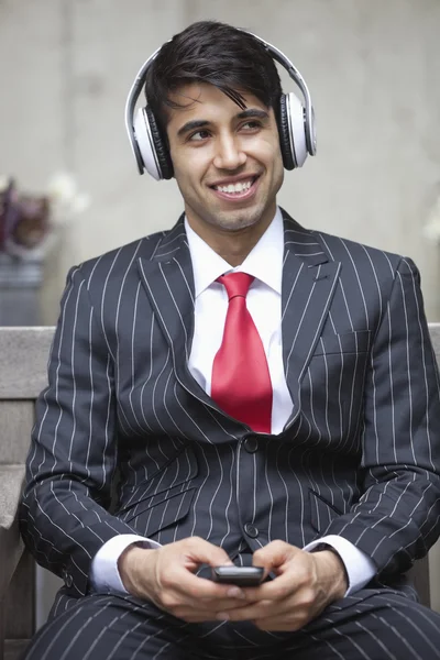 Indian businessman listening music — Stock Photo, Image