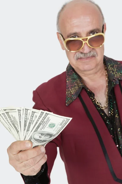 Senior man showing US banknotes — Stock Photo, Image