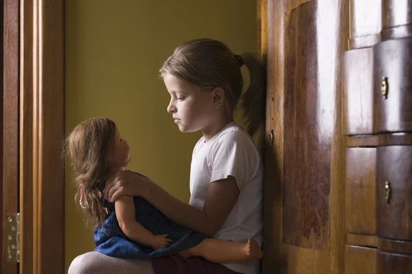 Girl playing with doll — Stock Photo, Image