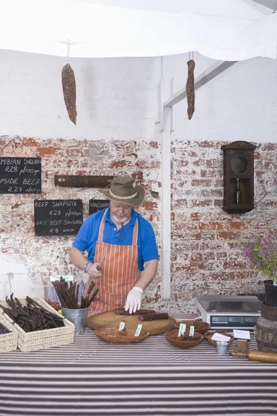 Man prepares sausages — Stock Photo, Image